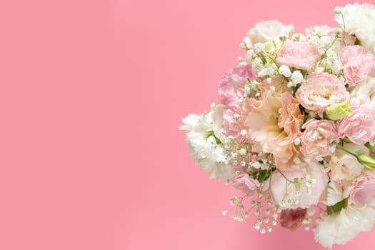 top view of beautiful romantic bouquet fresh spring flower on pink background with copy space