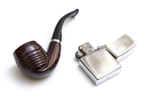 Smoking pipe and silver lighter on a white background
