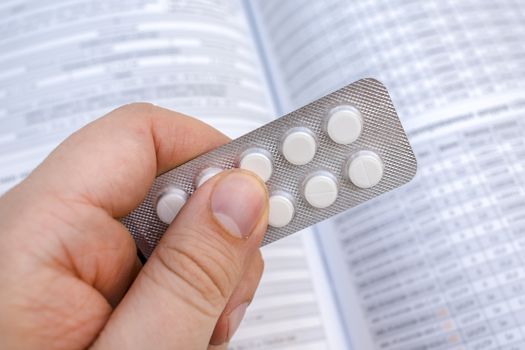 Packing tablets in the hands of a patient or doctor. Medications for treating patients in a pharmacy
