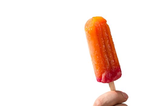 Juicy popsicles on a stick in a hand on a white background