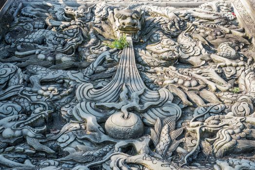Stone dragon bas-relief sculpture fresco in a buddhist temple in Yunding Shicheng, Sichuan province, China