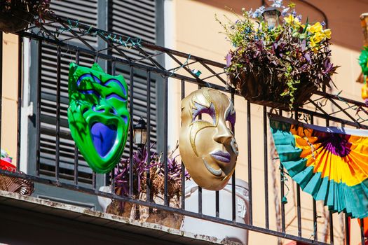 Flowers in baskets hang off shutter doors during Mardi Gras in New Orleans, Louisiana, USA