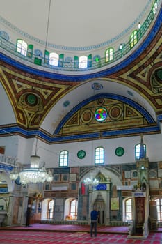 ACRE, ISRAEL - SEPTEMBER 18, 2017: View of the interior of El-Jazzar Mosque (the white mosque), with prayers, in Acre (Akko), Israel