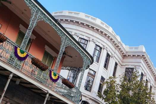 Flowers in baskets hang off shutter doors during Mardi Gras in New Orleans, Louisiana, USA