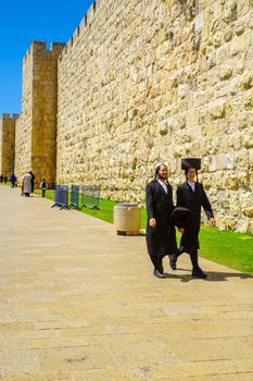 JERUSALEM, ISRAEL - APRIL 29, 2016: Ultra-Orthodox Jews and other visitors, near Jaffa gate, part of the walls of the old city, in Jerusalem, Israel