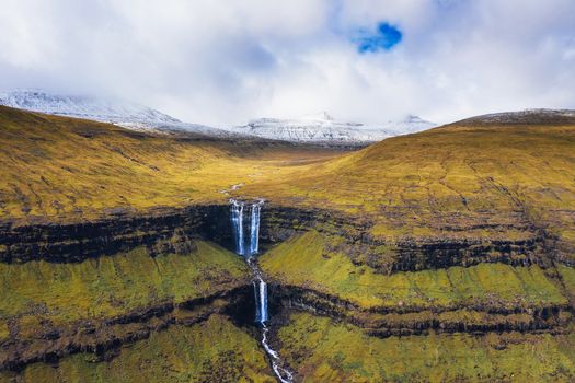 Aerial view of the Fossa Waterfall on island Bordoy. This is the highest waterfall in the Faroe Islands, situated in wild scandinavian scenery.