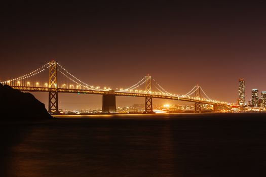 The Bay Bridge at night between Oakland and San Francisco from Treasure Island