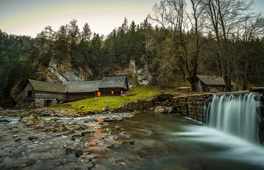 Old wooden water mill at National Nature Reserve Kvacianska dolina in Slovakia after sunset.  It has been restored and serves as a museum. Long exposure.