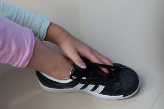 Bangkok ,Thailand,July 18 ,2018-kid hand touch black sneaker shoes brand Adidas
