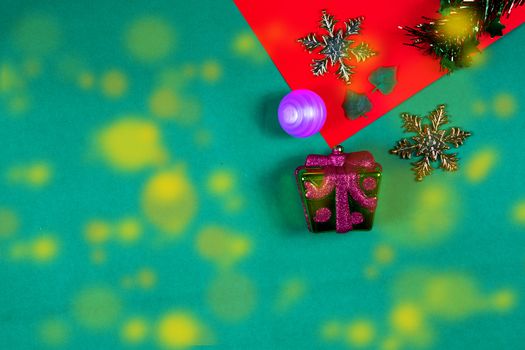 Christmas bauble,snow flake ,presents ,star and leaves on Red green background with snow fall,top  view with copy space