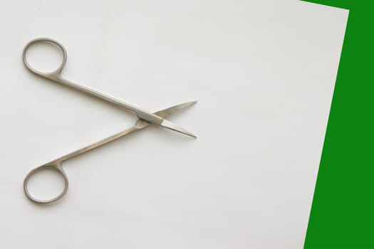 doctor scissors  on white green background with copy space