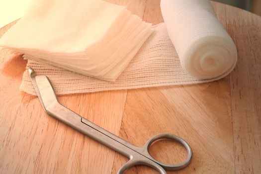 Dressing or clean wound tools includes Roll gauze,pile of gauzes and gauze roll cutter or scissors with sun flare