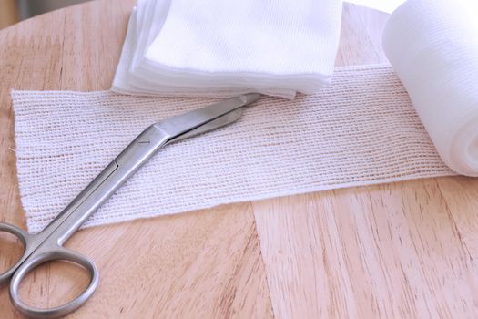 Dressing or clean wound tools includes Roll gauze,pile of gauzes and gauze roll cutter or scissors