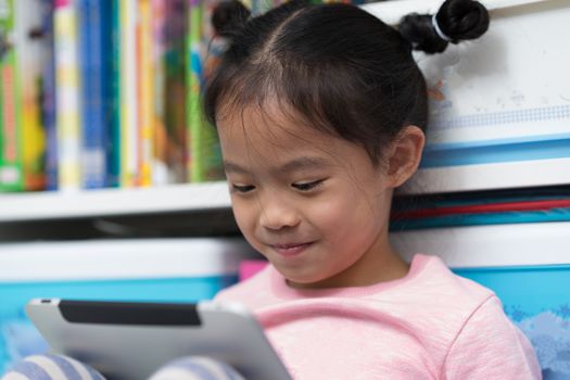 closed up asian thai girl child kid sit book self funny to reading tablet