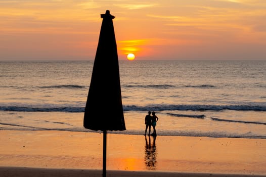 man and woman waiting for sunset