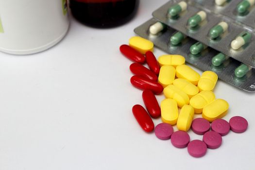 Medical tablets and packages on white floor in drugstore medical healthcare concept with copy space