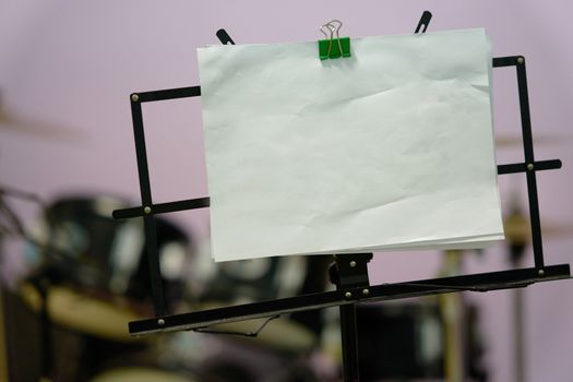Music stand with Mock up notes paper on blur drum background