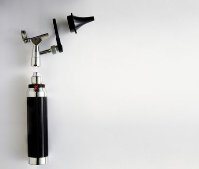 Otoscope for ENT doctor exam ear on pieces disassembly with copy space on white background