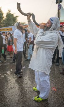 MERON, ISRAEL - MAY 26, 2016: Jewish men blows a shofar at the annual hillulah of Rabbi Shimon Bar Yochai, in Meron, Israel, on Lag BaOmer Holiday