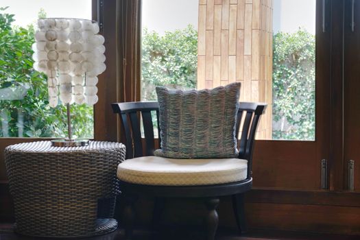 sofa or armchair with table lamp with window view