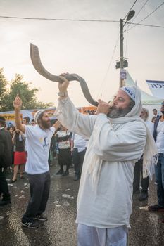 MERON, ISRAEL - MAY 26, 2016: Jewish men blows a shofar at the annual hillulah of Rabbi Shimon Bar Yochai, in Meron, Israel, on Lag BaOmer Holiday