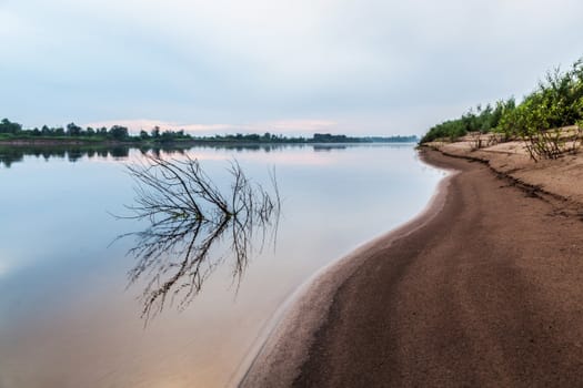 A gentle sandy beach near the river. Flying landscape by the river.