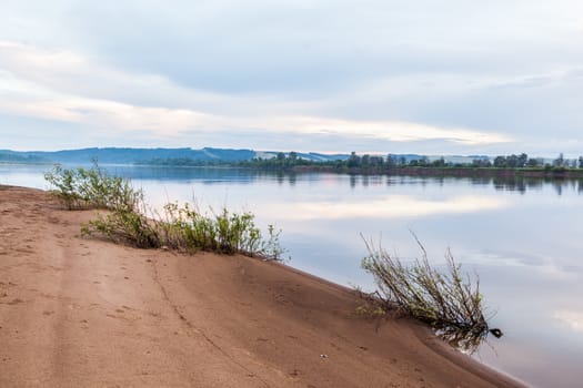 A gentle sandy beach near the river. Flying landscape by the river.