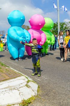 Nesher, Israel - March 22, 2019: People, some in costumes, celebrate the Jewish holyday of Purim in the Adloyada parade, in Nesher, Israel