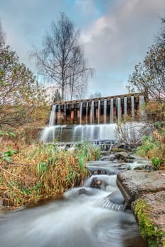 Small dam with a waterfall on the river