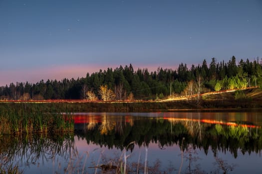 Beautiful pink sunset over the river and forest