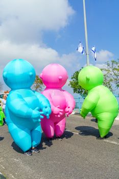 Nesher, Israel - March 22, 2019: People, some in costumes, celebrate the Jewish holyday of Purim in the Adloyada parade, in Nesher, Israel