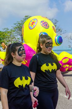 Nesher, Israel - March 22, 2019: People, some in costumes, celebrate the Jewish holyday of Purim in the Adloyada parade, in Nesher, Israel