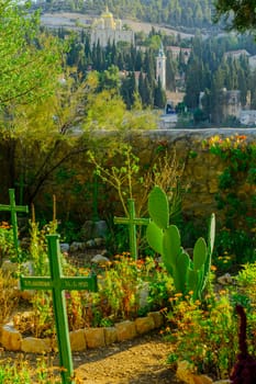 JERUSALEM, ISRAEL - OCT 26, 2017: The cemetery of the Sisters of Our Lady of Zion monastery, with the Church of the Visitation and the Moscobia Convent in the background. Ein Karem, Jerusalem, Israel