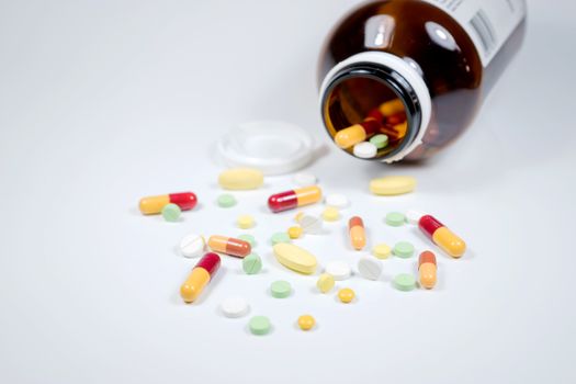 Pills from bottle on the white