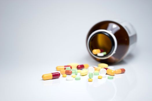 Pills from bottle on the white