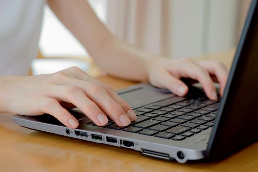 programmer's hand typing with laptop. focus on his finger 