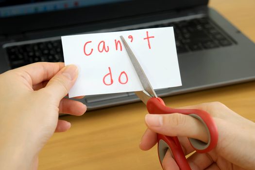 holds card with text can't do on computer