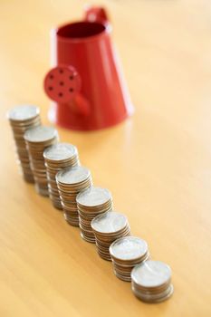 Red watering can with coin (path in side) isolate