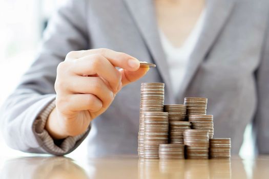 Close-up Of A Businesswoman Making Stack Of Coins