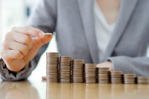 Close-up Of A Businesswoman Making Stack Of Coins