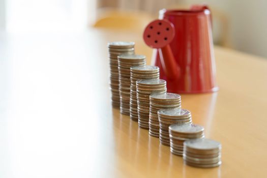 Red watering can with coin (path in side) isolate