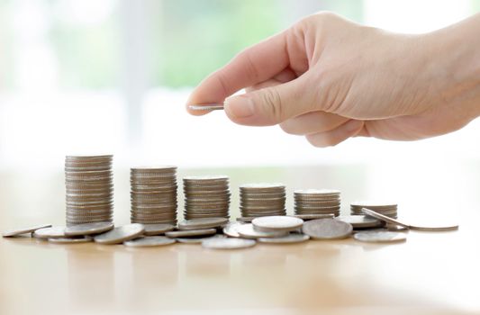 Hand human hand putting coin to money, business ideas