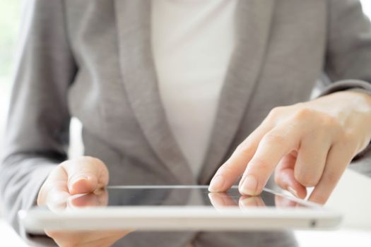 Digital tablet in the hands of businesswomen