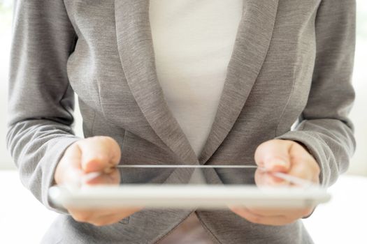 Digital tablet in the hands of businesswomen