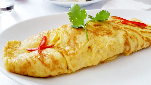 closeup of a plate with a typical tortilla de patatas, spanish omelet, on a set table