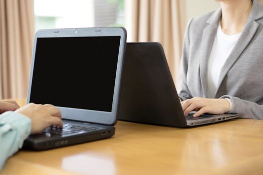 Young business couple using laptop