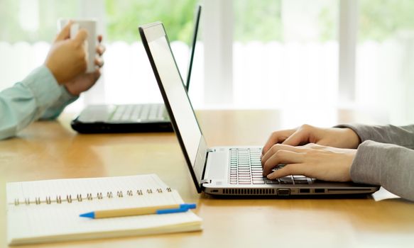 Business people working with laptop computer in office