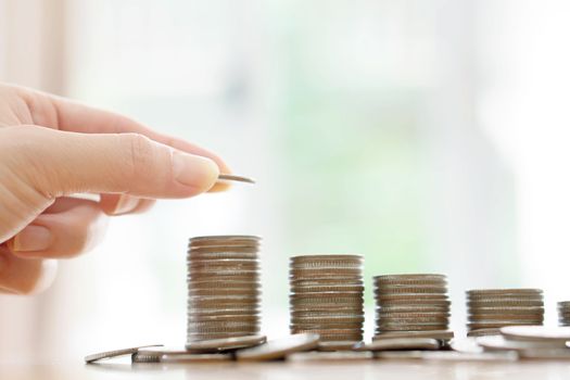 Saving money concept,Male hand putting money coin stack growing business