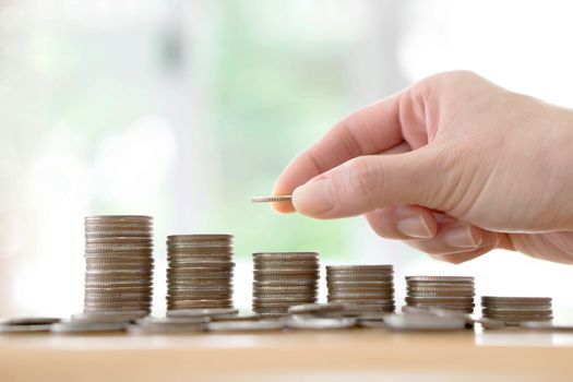 Hand human hand putting coin to money, business ideas