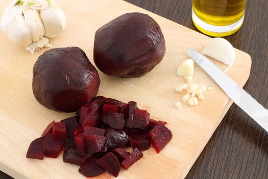 Cut beetroot on wooden chopping board